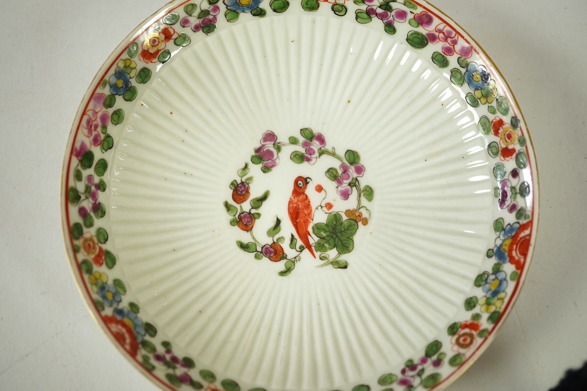 A Worcester Old Worcester Parrot pattern tea bowl and saucer, c.1765-68, saucer 11.5cm in diameter